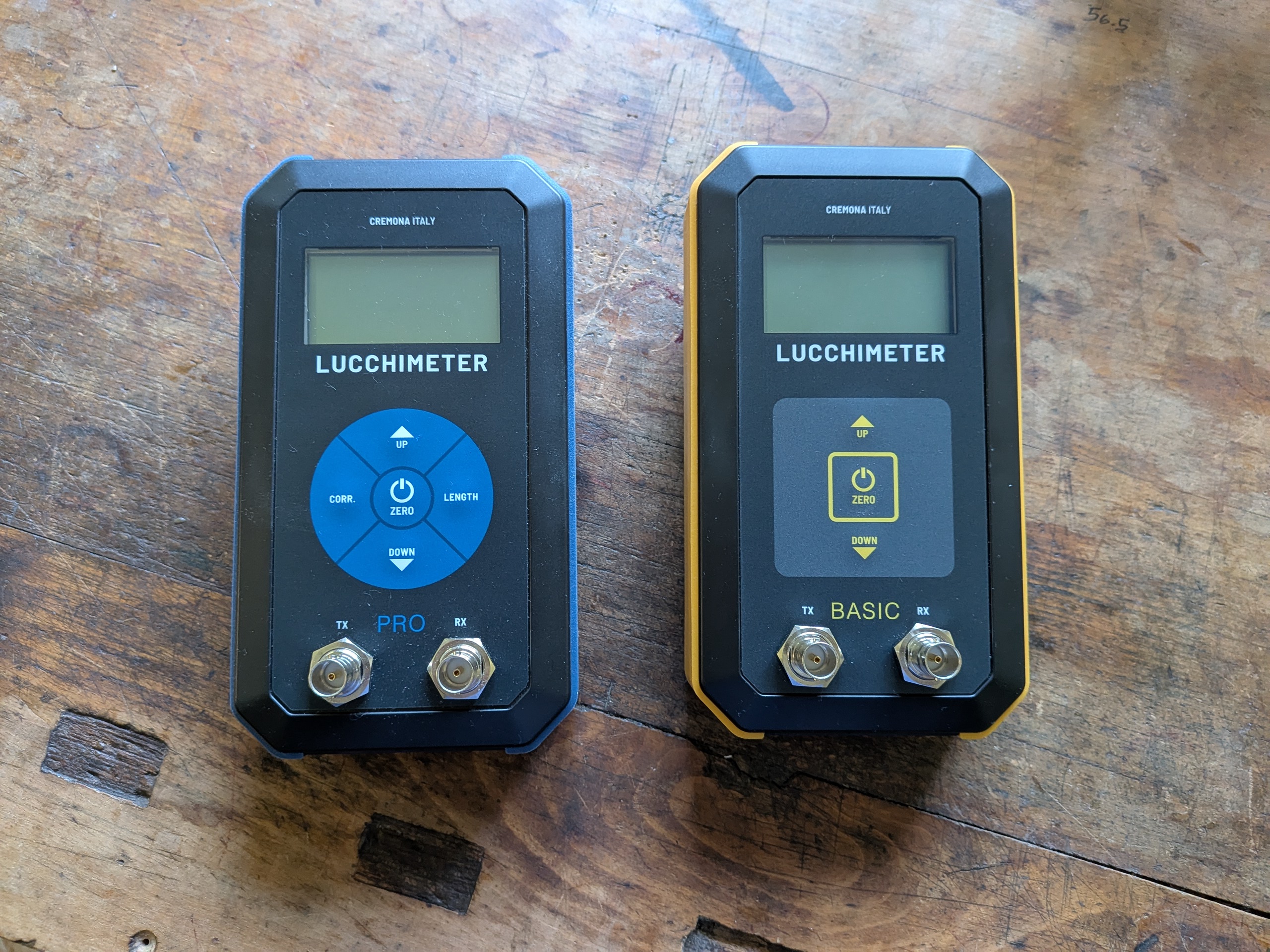 LucchiMeter PRO and BASIC side by side on a wooden workbench